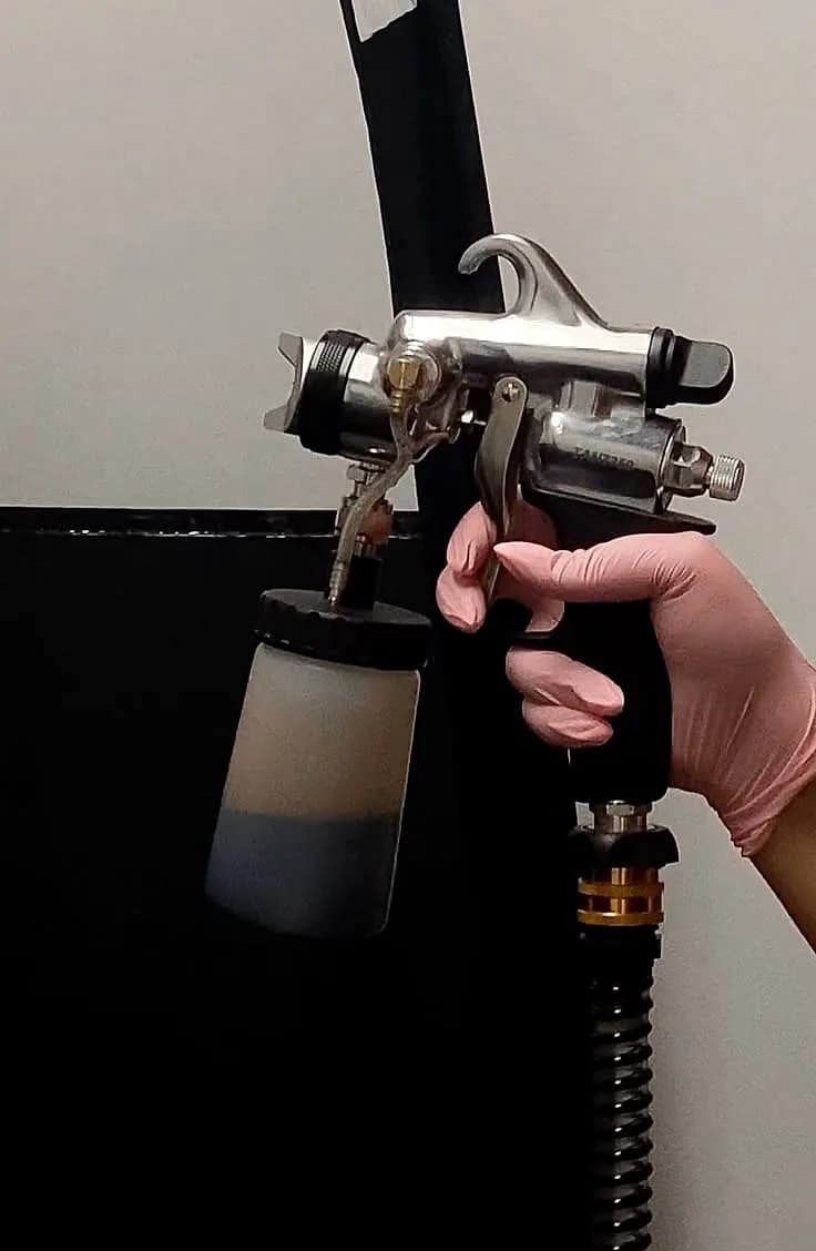 A Glowtoure custom spray tan applied by hand with a professional airbrush gun
